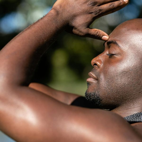 Person meditating peacefully in a bright, sunlit space.
